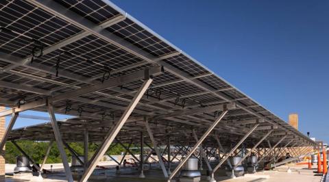 Elevated solar canopy on angled aluminum supports along the roof of 3801 Connecticut Ave.