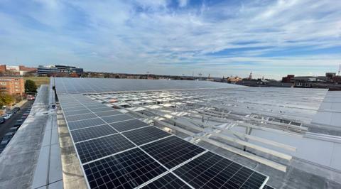 Elevated flush mount solar array being installed across the large roof at Burr