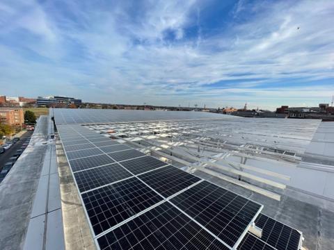 Elevated Flush Mount solar array being installed across a large roof