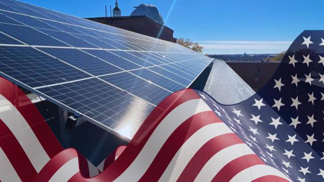 Rooftop solar panels with an American flag