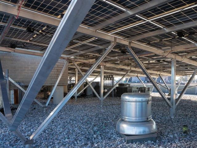 Roof exhaust vent standing beneath the elevated solar canopy at 1441 Rhode Island Ave.