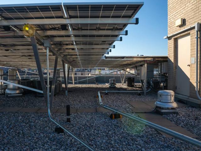 Underside of the solar canopy at 1441 Rhode Island Ave., with conduit run beside the penthouse door