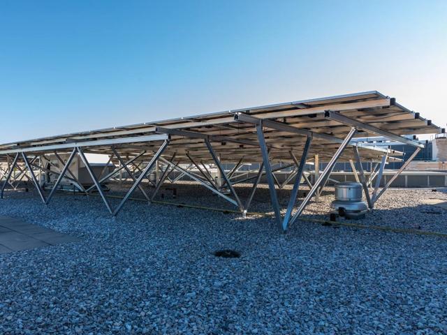 Solar canopy on W-shaped aluminum supports over the gravel roof at 1441 Rhode Island Ave.