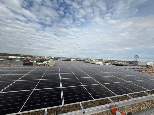 Flush mount solar array across the roof of 1909 Aurora Energy