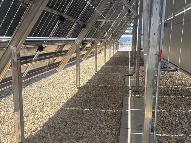 Supports behind the high tilt solar array at 1909 Aurora Energy