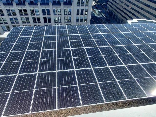 Solar array at 1909 Aurora Energy with office buildings behind