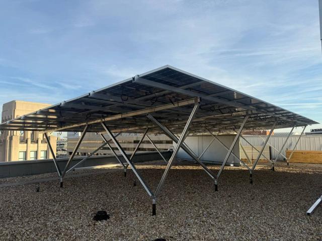 Elevated W System solar canopy on the roof of 1909 Aurora Energy