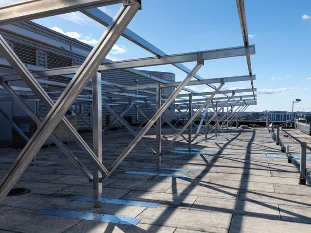 Elevated aluminum racking with knee bracing on the roof of 20 M Street
