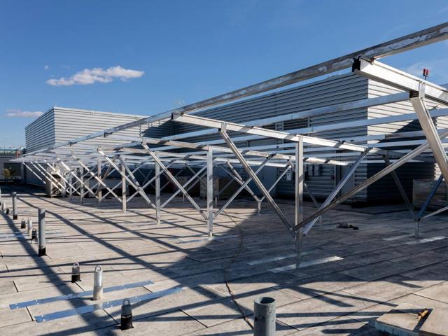 Rows of elevated racking frames across the roof of 20 M Street