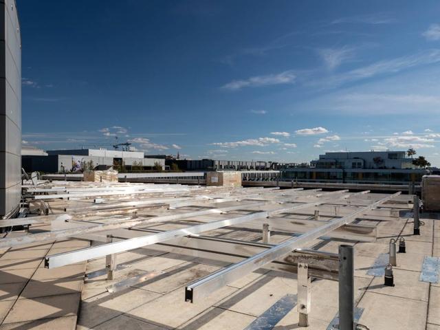 Low flush mount racking rails laid out across the roof of 20 M Street
