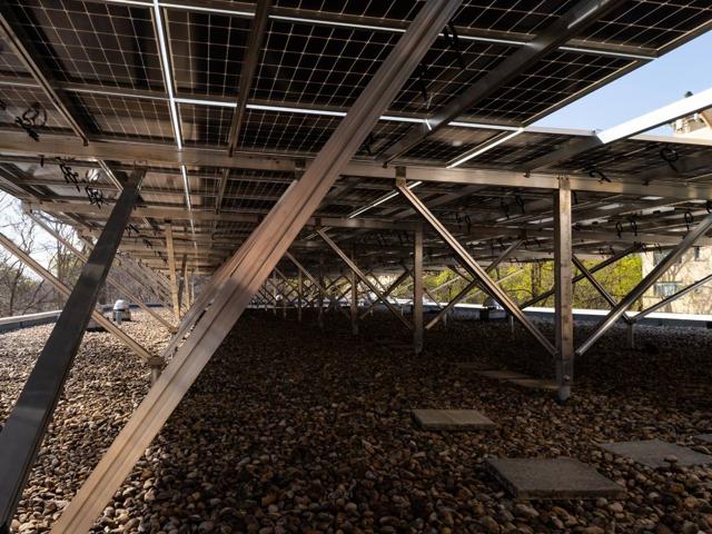 Underside of the solar canopy at 3801 Connecticut Ave., showing aluminum bracing over the gravel roof