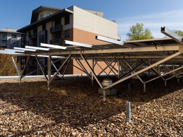 Solar canopy racking at the roof edge of 3801 Connecticut Ave., with an apartment building behind