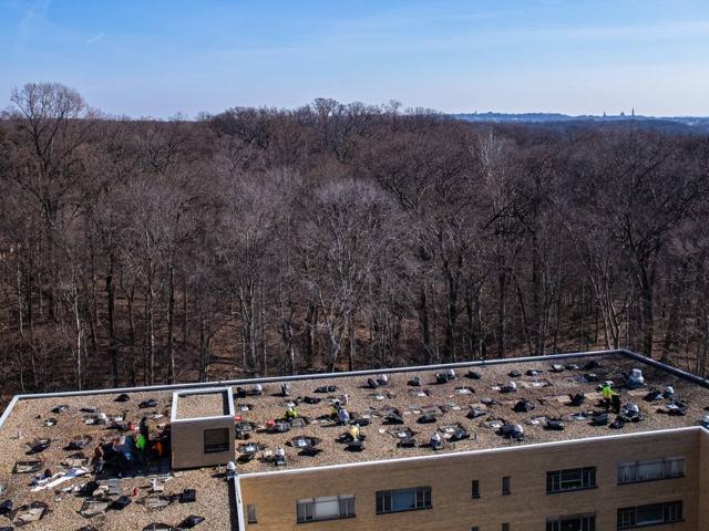 Aerial view of crews setting racking bases on the roof of 3801 Connecticut Ave.