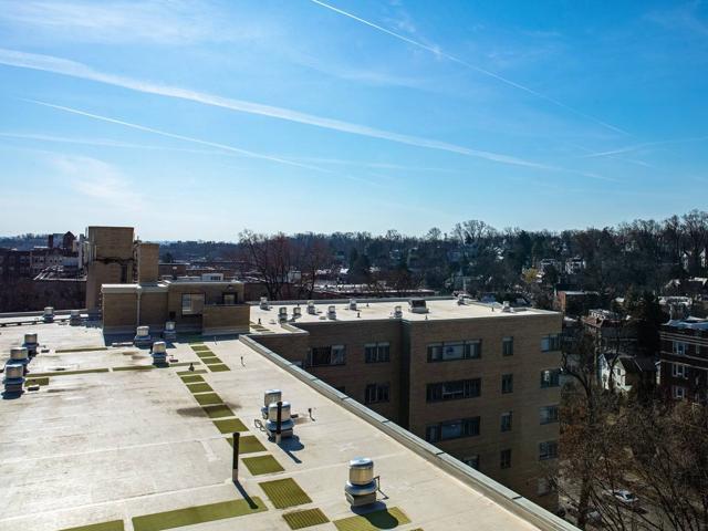 Roof of 3801 Connecticut Ave. before installation, with rooftop equipment and a walkway