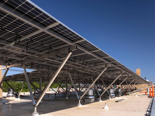 Elevated solar canopy on angled aluminum supports along the roof of 3801 Connecticut Ave.