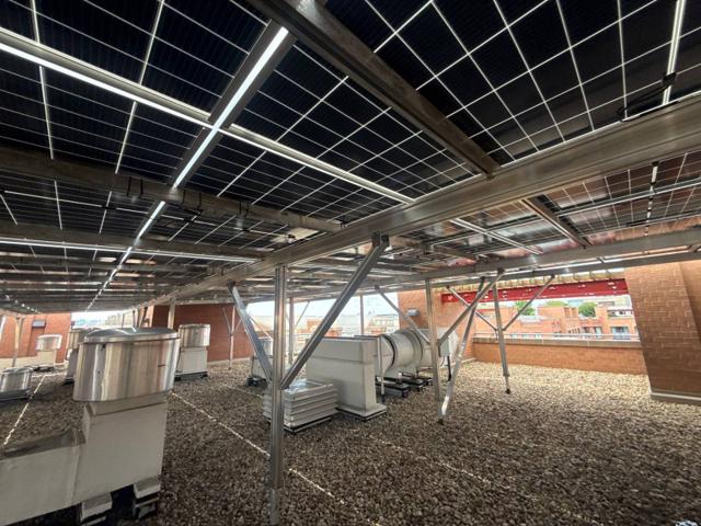 Rooftop exhaust fans and ducts beneath the solar canopy at 616