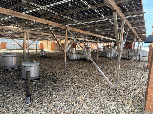 Rows of roof exhaust fans under the elevated solar canopy at 616