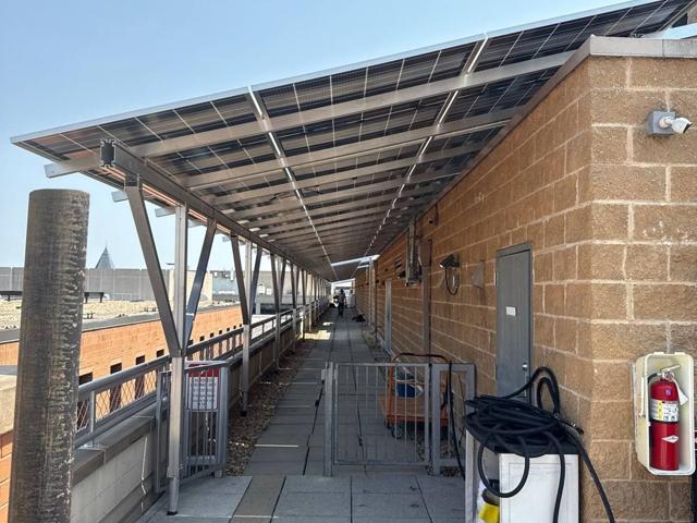 Solar canopy over a roof terrace walkway at 616