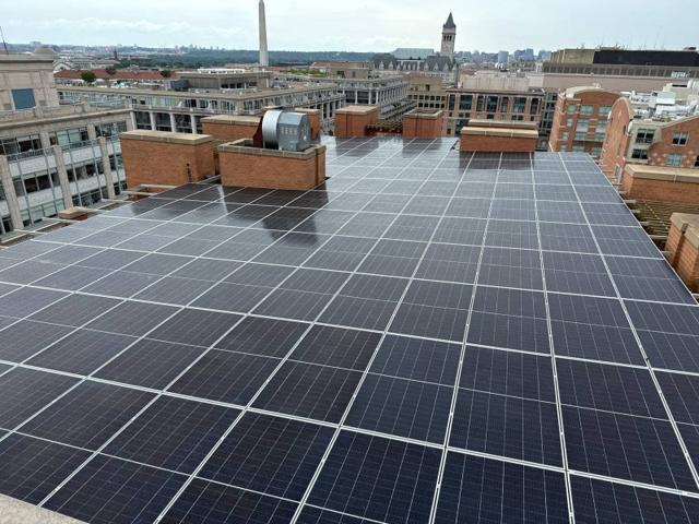 Solar canopy on the roof at 616, with the Old Post Office tower and Washington Monument beyond