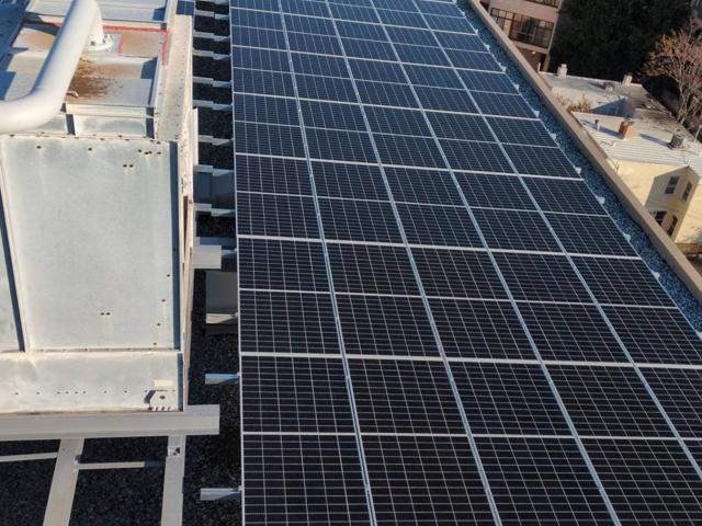 Aerial view of the solar array beside a cooling tower at 925