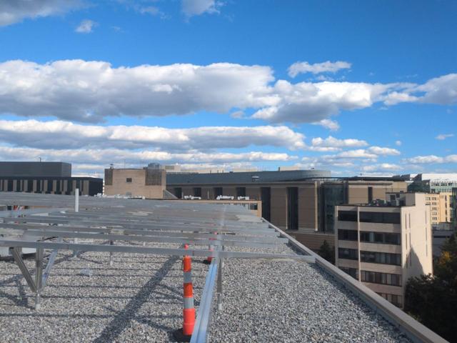 Racking frame across the roof at 925, with office buildings behind
