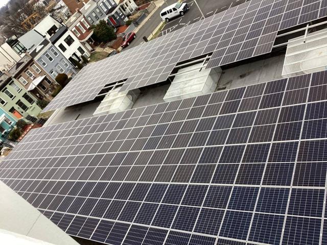 Aerial view of the solar canopy on the roof of Burr, with rowhouses beyond