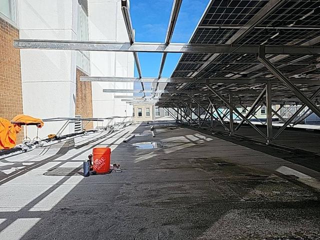 Roof walkway beneath the elevated solar canopy at Burr