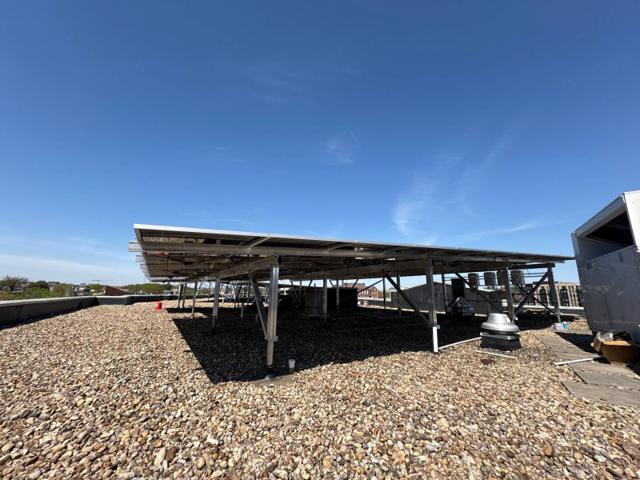 Elevated flush mount solar canopy on the gravel roof at GRP