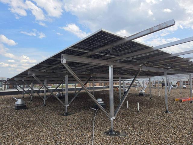 Elevated solar canopy on braced aluminum posts at GRP