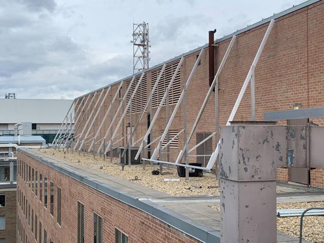 High Tilt racking frame against a brick penthouse wall before the panels