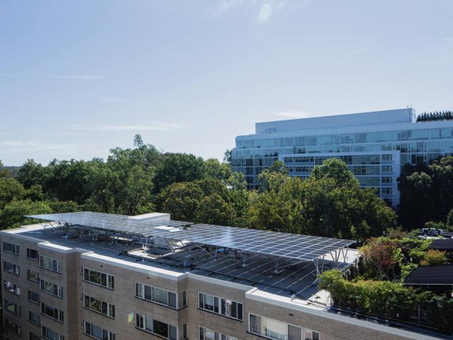 Kenmore with its rooftop solar canopy, seen from a neighboring roof