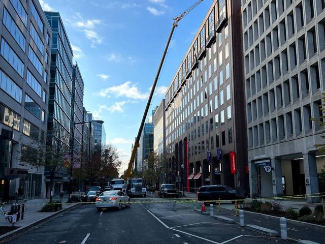 Crane on the street beside the Lafayette building