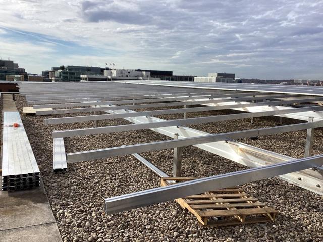 Aluminum racking rails laid out on the gravel roof at Lafayette
