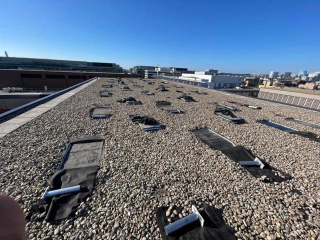 Attachment bases flashed into the roof of Lafayette before the racking goes up