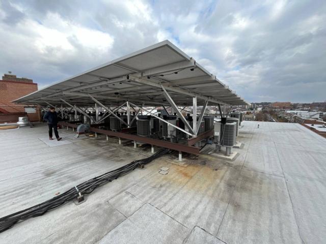 Elevated solar canopy over a row of condensers at Randolph Towers