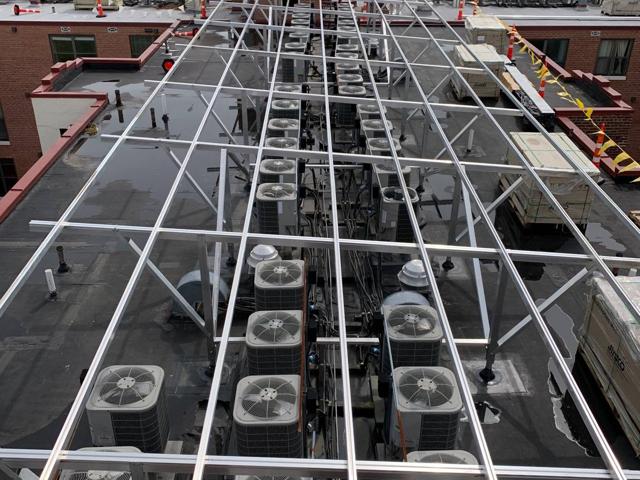Racking frame spanning the rooftop condensers at Randolph Towers