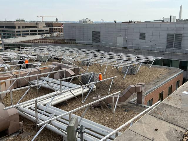 W System racking being installed over rooftop ductwork and piping