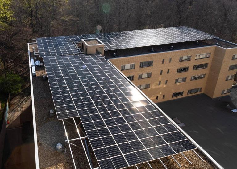 Aerial view of the L-shaped solar canopy on the roof of 3801 Connecticut Ave.