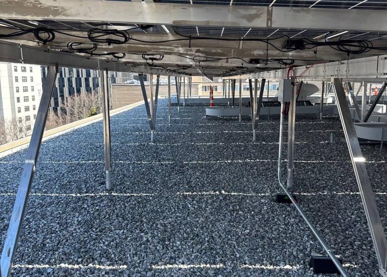 Beneath the solar canopy over the gravel roof at 925