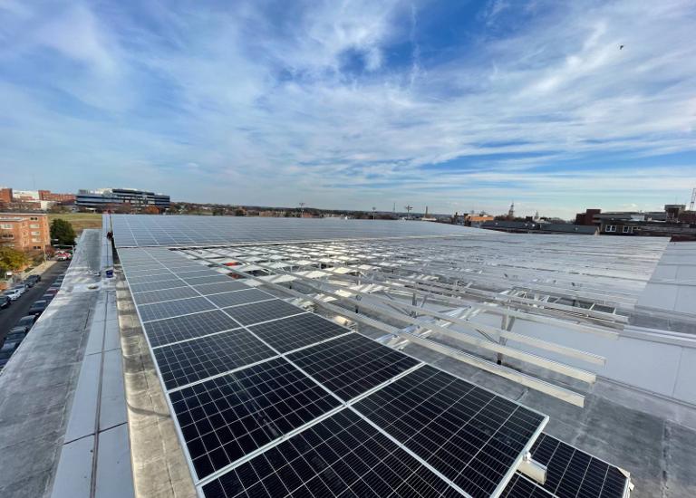 Elevated flush mount solar array being installed across the large roof at Burr