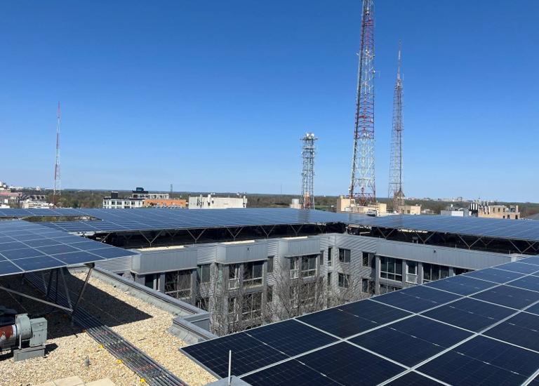 Solar canopy around the courtyard at Cityline, with broadcast towers behind