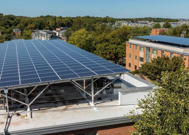 Solar canopy on the roof of a brick apartment building at Fitch & G St.