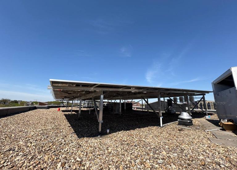 Elevated flush mount solar canopy on the gravel roof at GRP