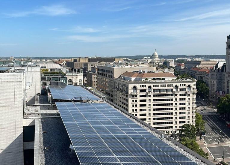 Solar array along the roof of Hotel DC, with downtown Washington beyond