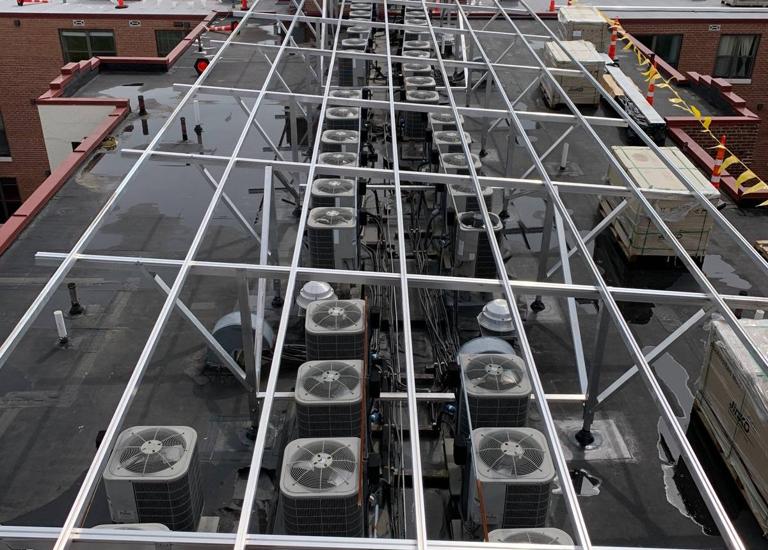 Racking frame spanning the rooftop condensers at Randolph Towers