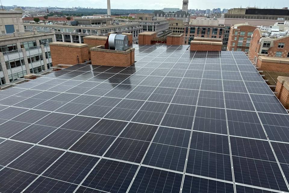 Solar canopy on the roof at 616, with the Old Post Office tower and Washington Monument beyond
