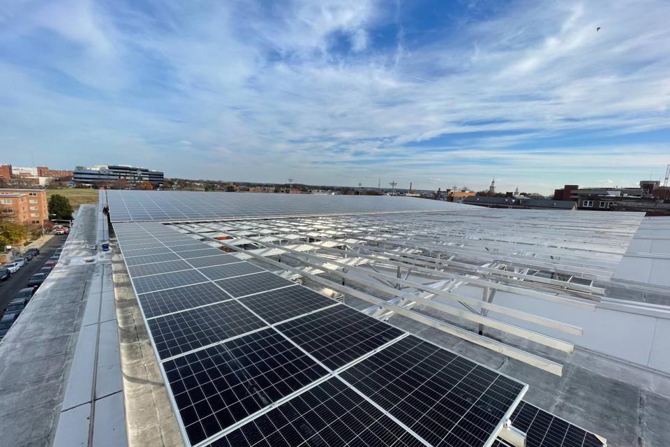 Elevated flush mount solar array being installed across the large roof at Burr