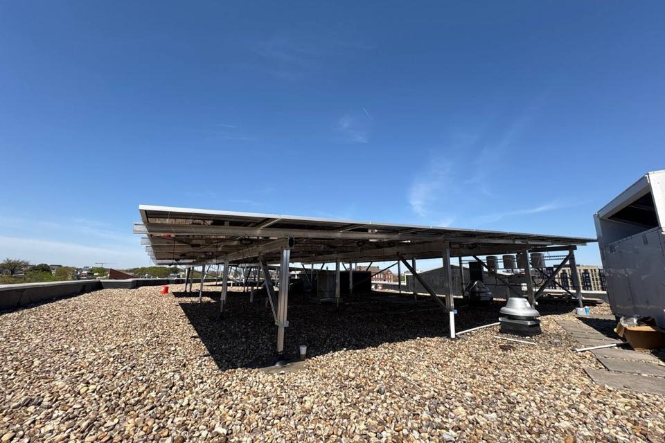 Elevated flush mount solar canopy on the gravel roof at GRP